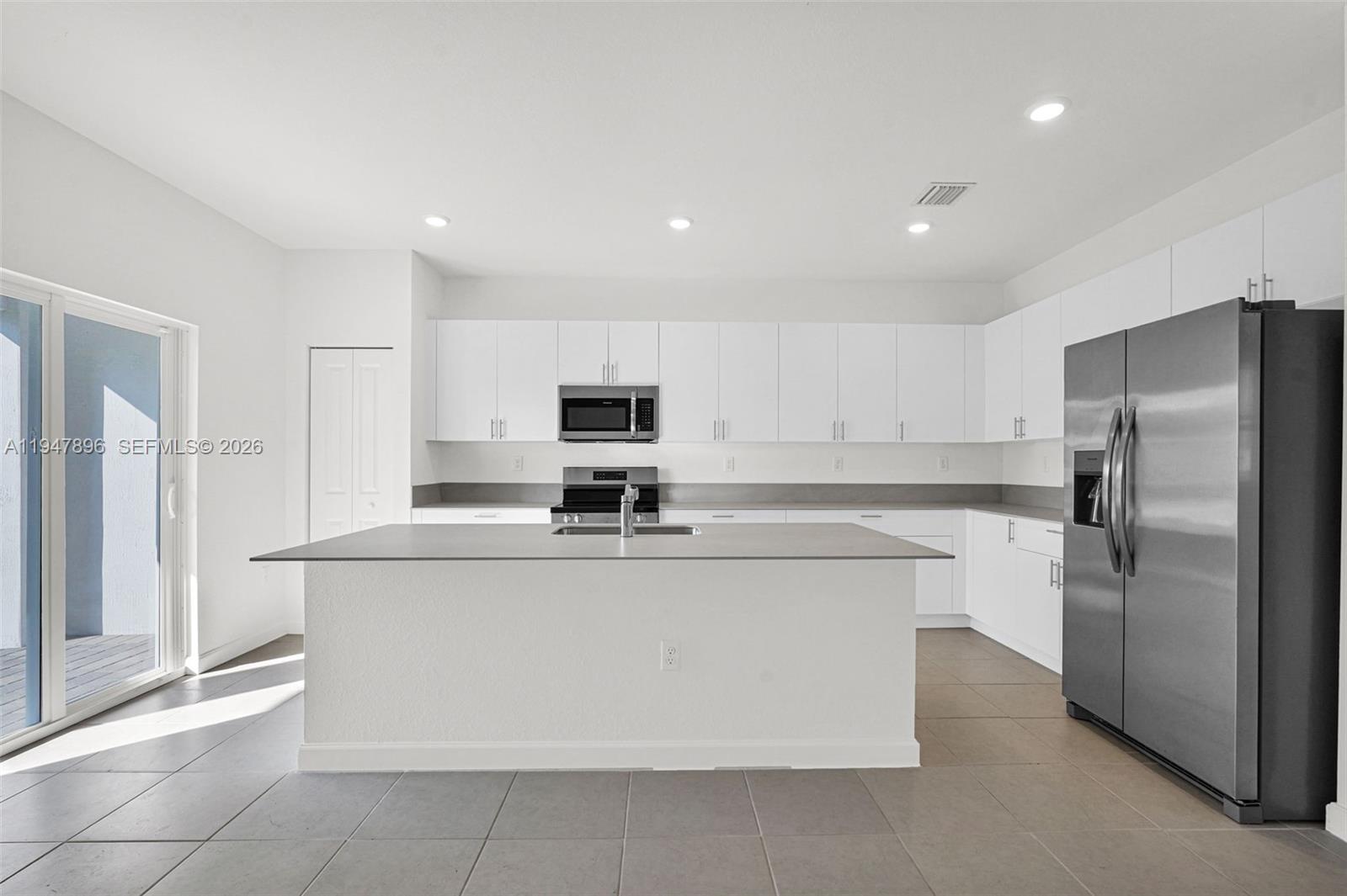 27210 Southwest 159th Path Homestead, FL 33031 - Photo 96 of 100 a kitchen with stainless steel appliances a refrigerator sink and microwave