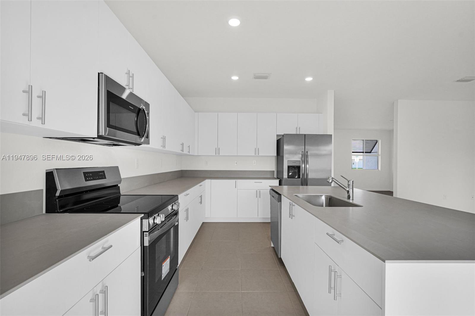 27210 Southwest 159th Path Homestead, FL 33031 - Photo 99 of 100 a kitchen with a sink stove and microwave
