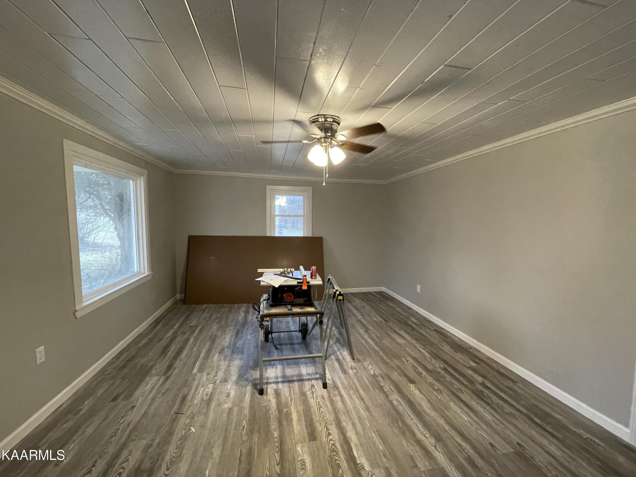 722 Yellow Cliff Road Jamestown, TN 38556 - Photo 11 of 13 a workspace with wooden floor a chandelier fan and a window