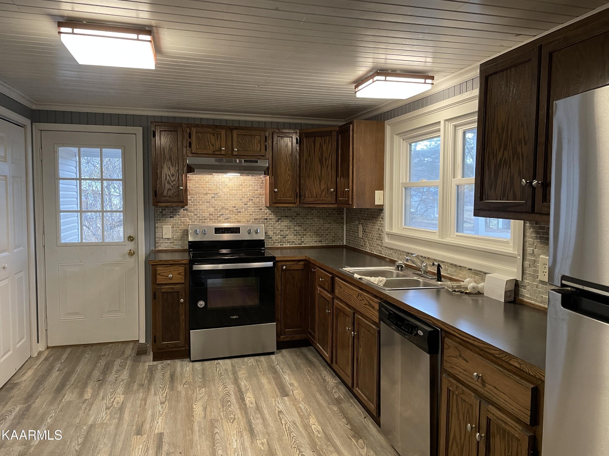 722 Yellow Cliff Road Jamestown, TN 38556 - Photo 3 of 13 a kitchen with granite countertop a sink cabinets and stainless steel appliances