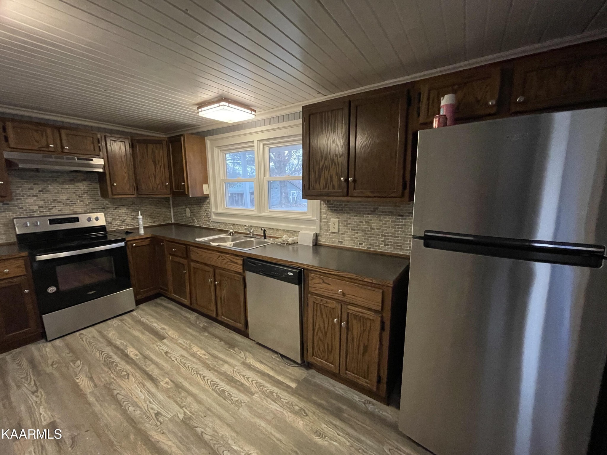 722 Yellow Cliff Road Jamestown, TN 38556 - Photo 5 of 13 a kitchen with stainless steel appliances granite countertop a refrigerator a sink and a stove