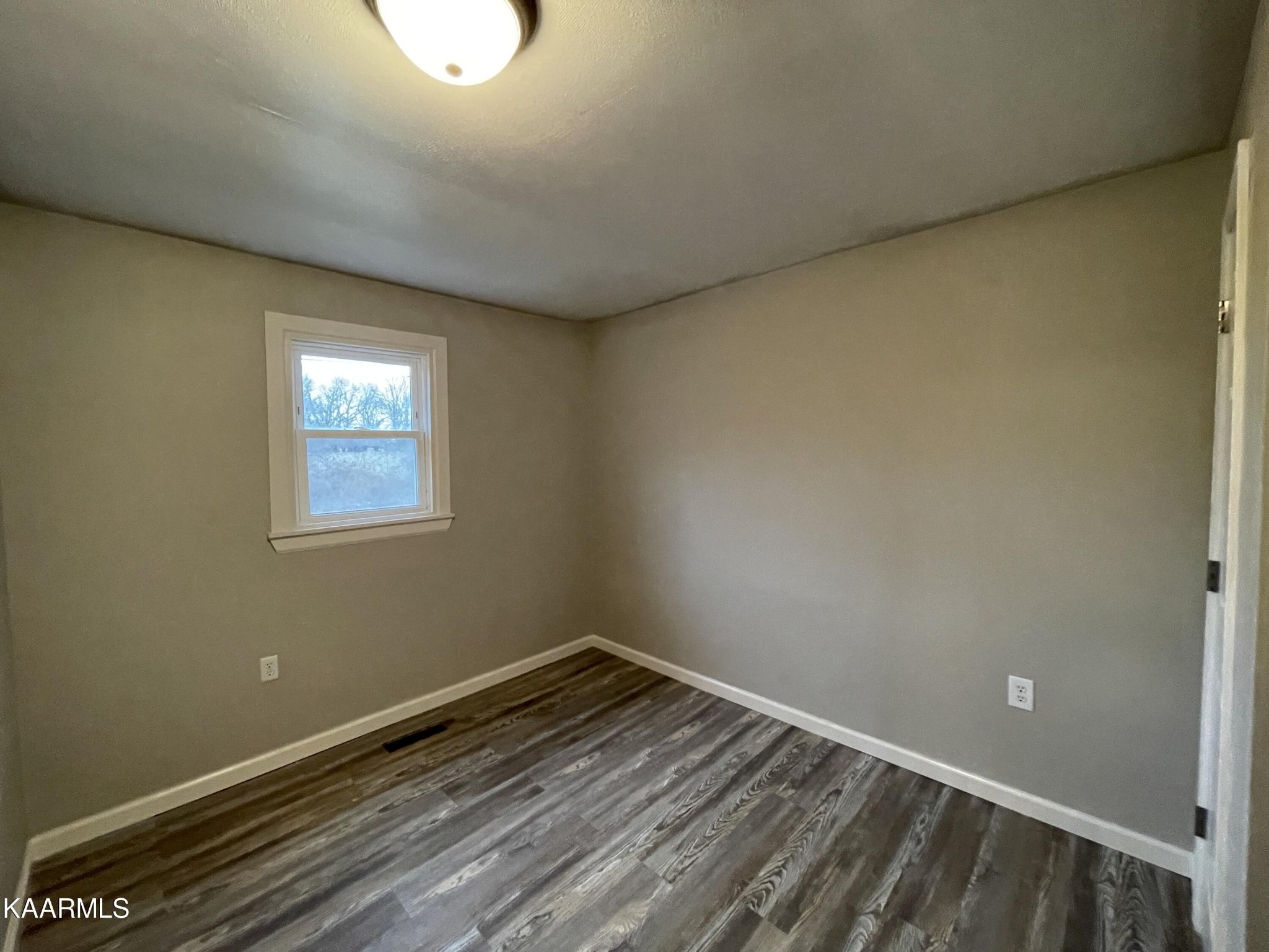 722 Yellow Cliff Road Jamestown, TN 38556 - Photo 10 of 13 a view of a room with wooden floor and windows