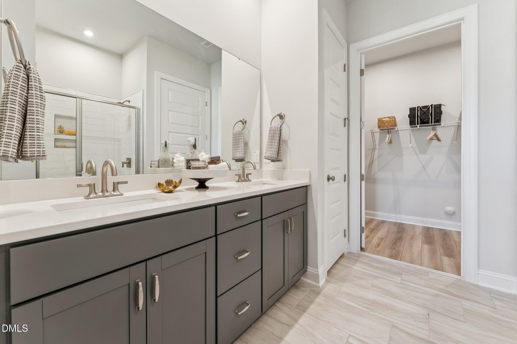 2124 Barrier Ridge Way Apex, NC 27502 - Photo 18 of 31 a bathroom with a double vanity sink mirror double and shower
