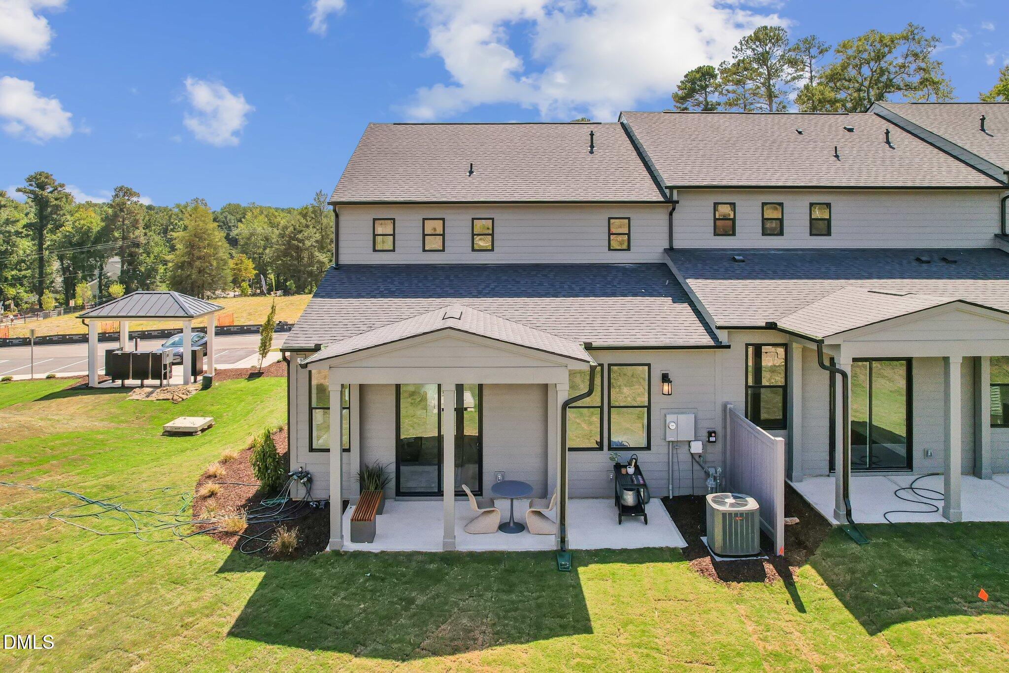 2124 Barrier Ridge Way Apex, NC 27502 - Photo 2 of 31 a front view of a house with a yard table and chairs
