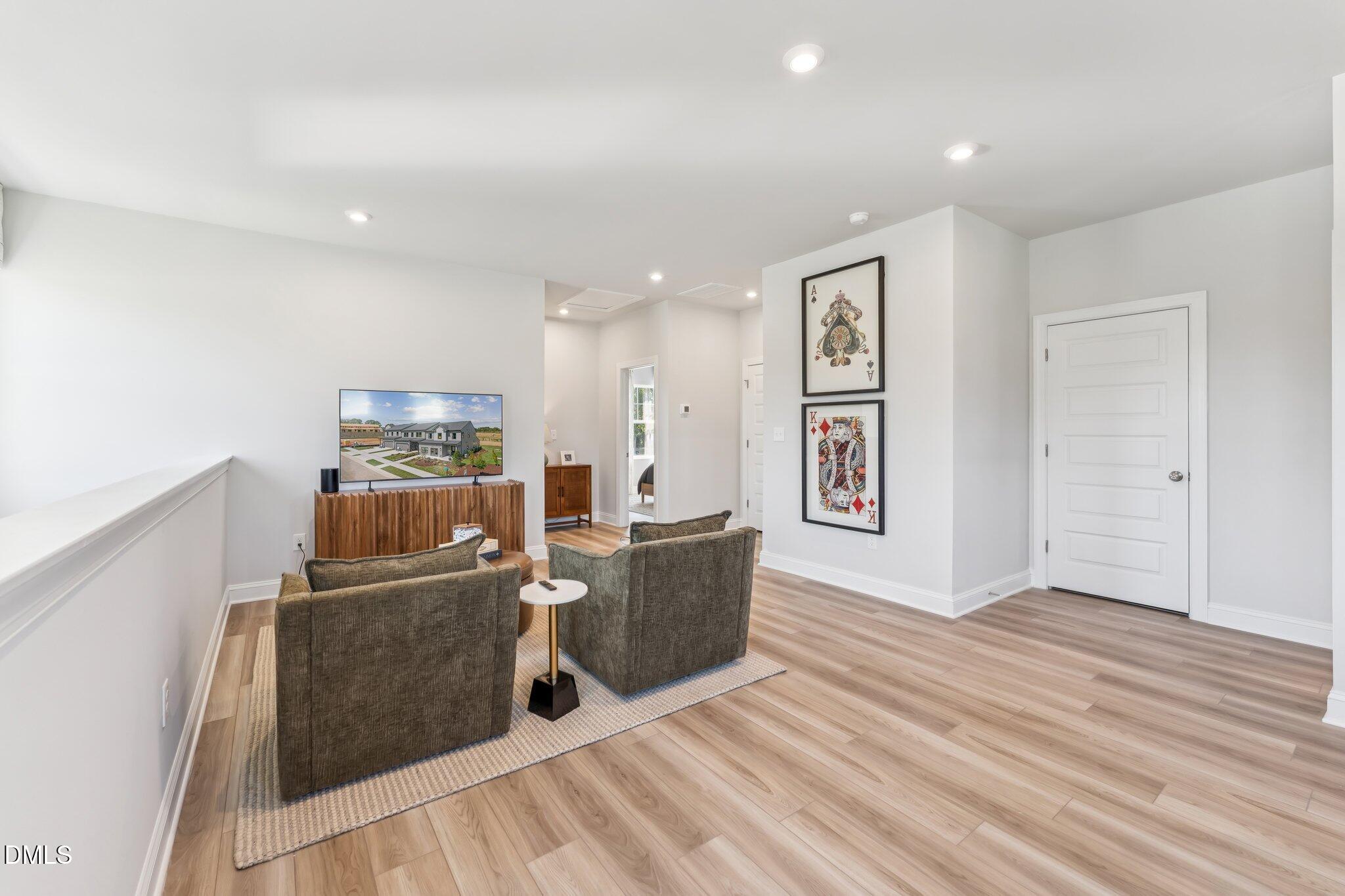 2124 Barrier Ridge Way Apex, NC 27502 - Photo 23 of 31 a living room with furniture and wooden floor