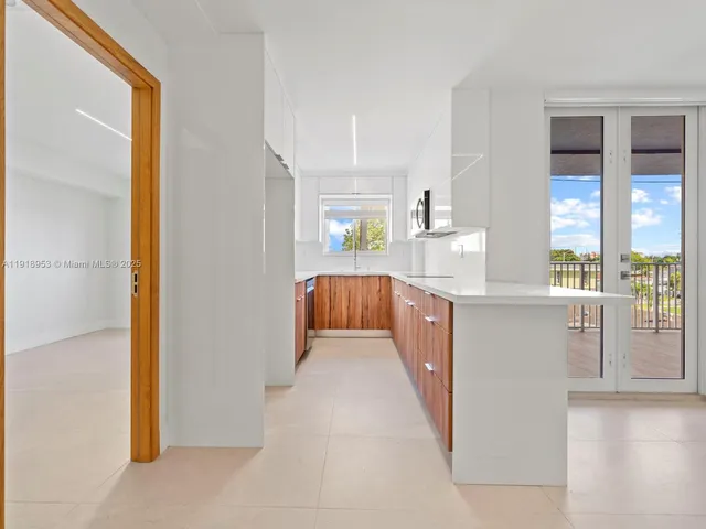 a kitchen with stainless steel appliances granite countertop a refrigerator and a stove