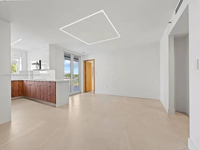a large white kitchen with a sink and cabinets