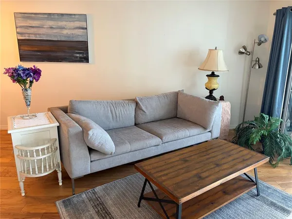 a living room with a couch and a potted plant