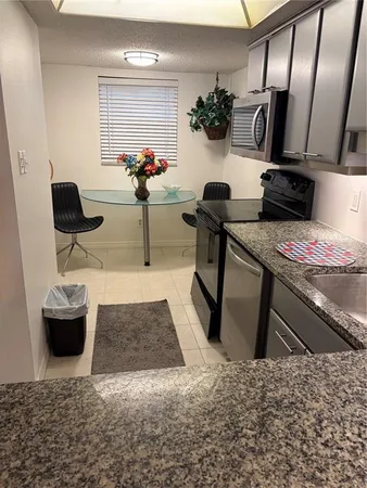 a room with furniture and a potted plant