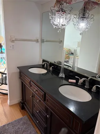 a bathroom with a granite countertop sink and a mirror