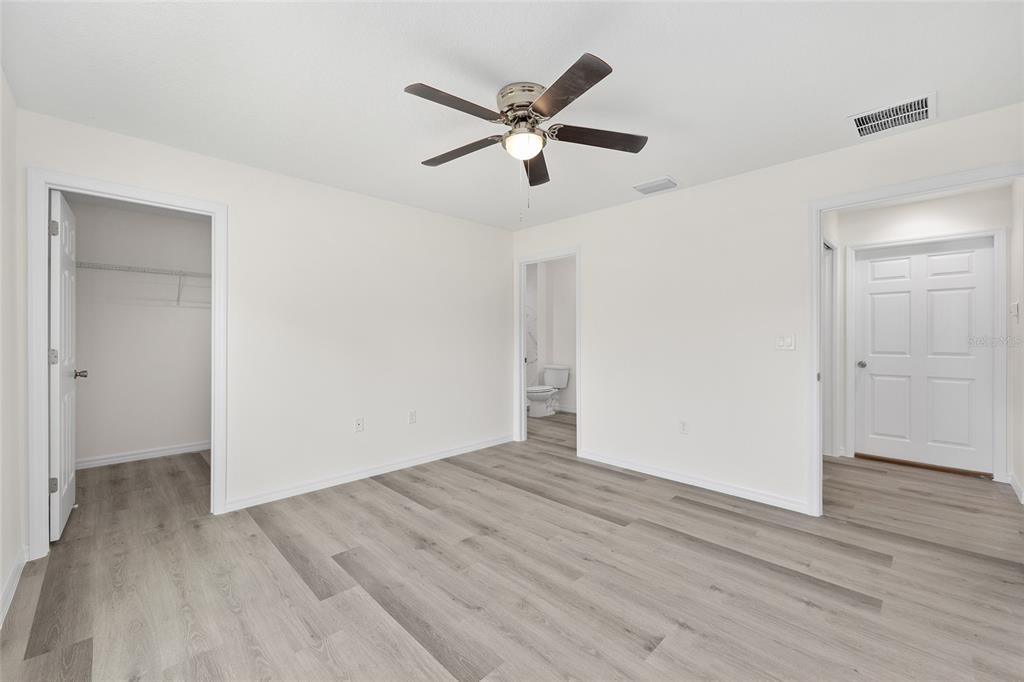 13019 Northeast 7th Loop Silver Springs, FL 34488 - Photo 22 of 35 a view of an empty room with wooden floor