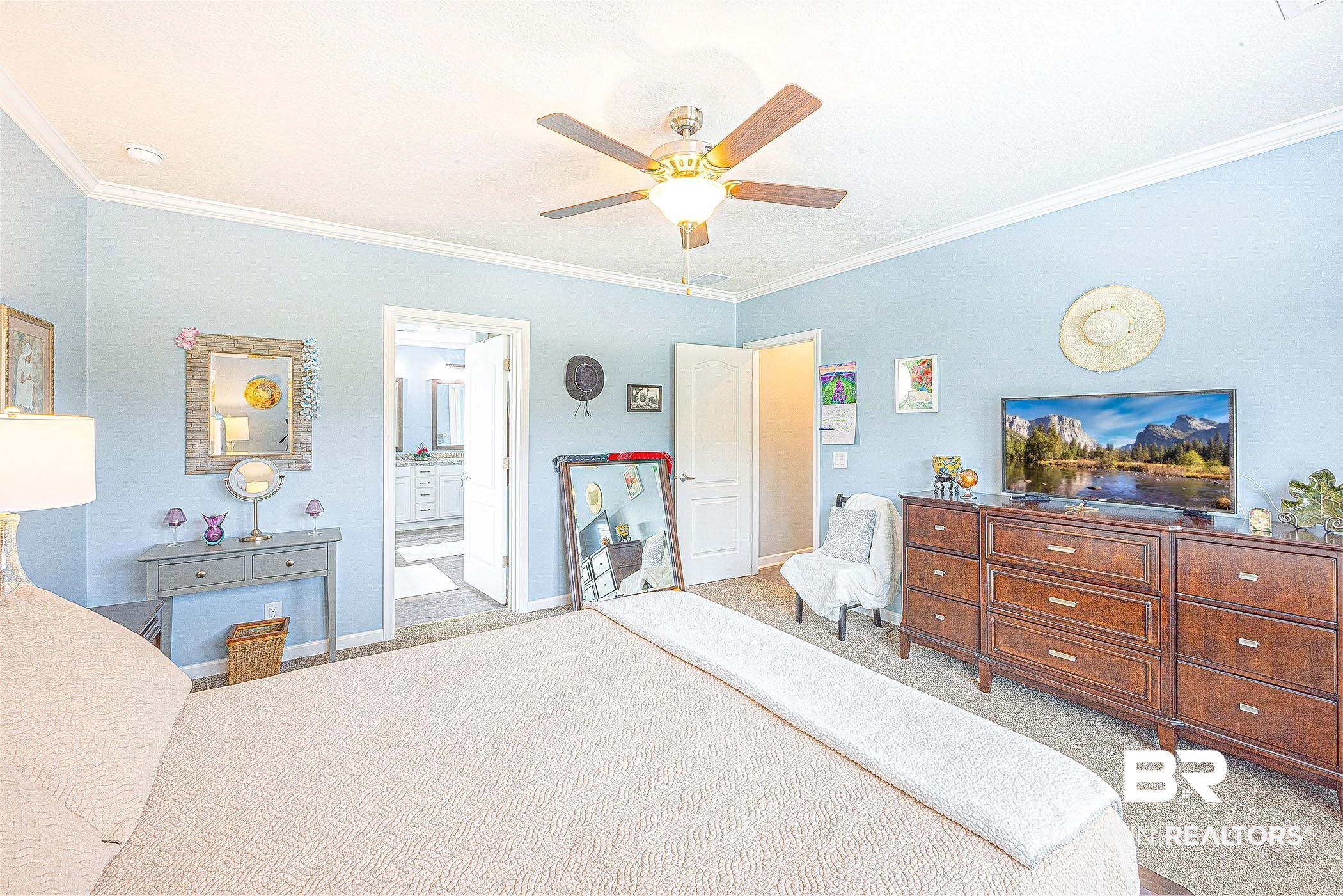 16000 John Bauer Road Summerdale, AL 36580 - Photo 20 of 34 Bedroom with light carpet, baseboards, connected bathroom, ceiling fan, and crown molding