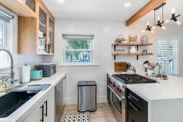 a kitchen with stainless steel appliances a sink stove and cabinets