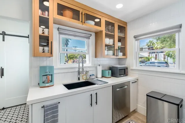 a kitchen with a sink cabinets and window