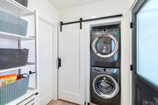 a view of a hallway with washer and dryer