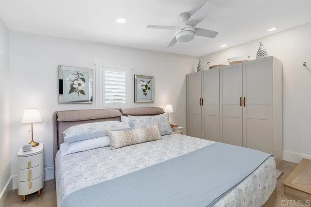 a bedroom with a large bed and a chandelier