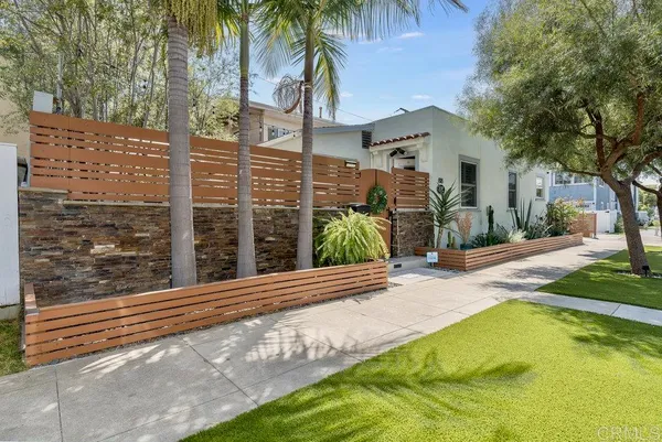 a view of a house with a yard and a tree