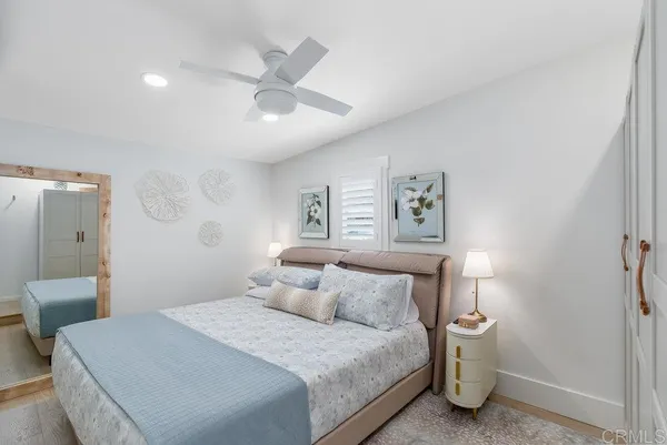 a bedroom with a bed and a painting on the wall