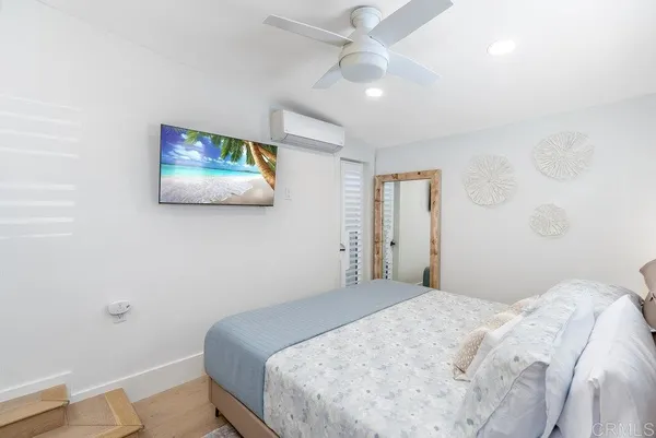 a bedroom with a bed and a painting on the wall