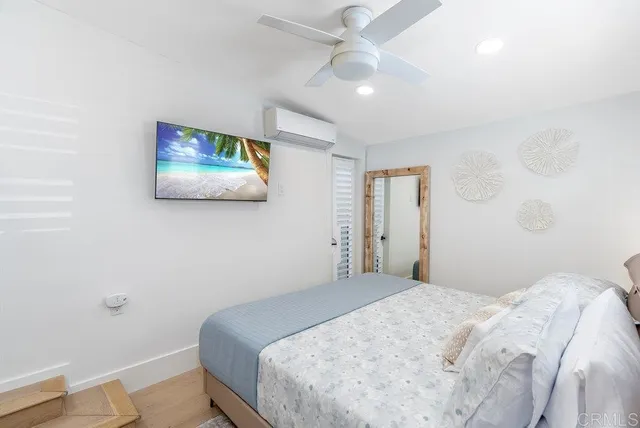 a bedroom with a bed and a painting on the wall