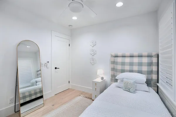 a bedroom with a bed and a mirror