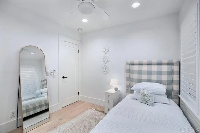 a bedroom with a bed and a mirror