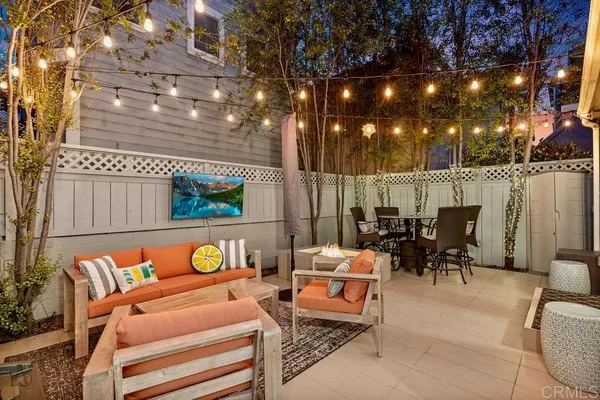 a backyard of a house with barbeque oven table and chairs