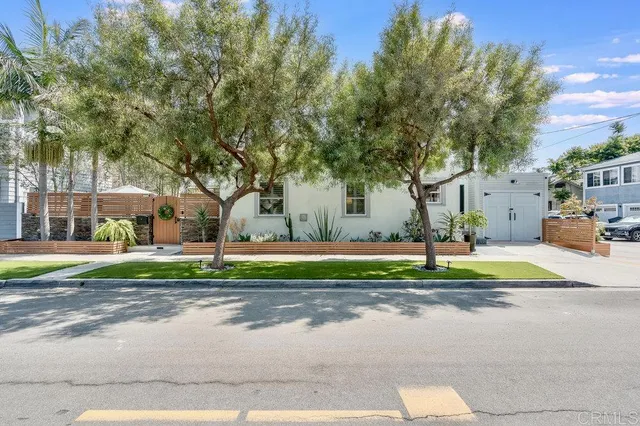 a house with green field in front of it