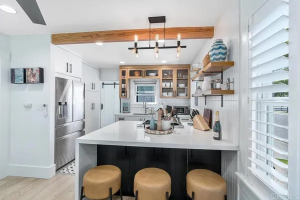 a kitchen with a table and chairs