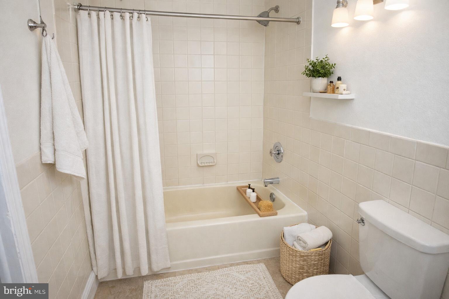 2309 East York Street, Unit 2R Philadelphia, PA 19125 - Photo 4 of 8 a white toilet sitting next to a bath tub
