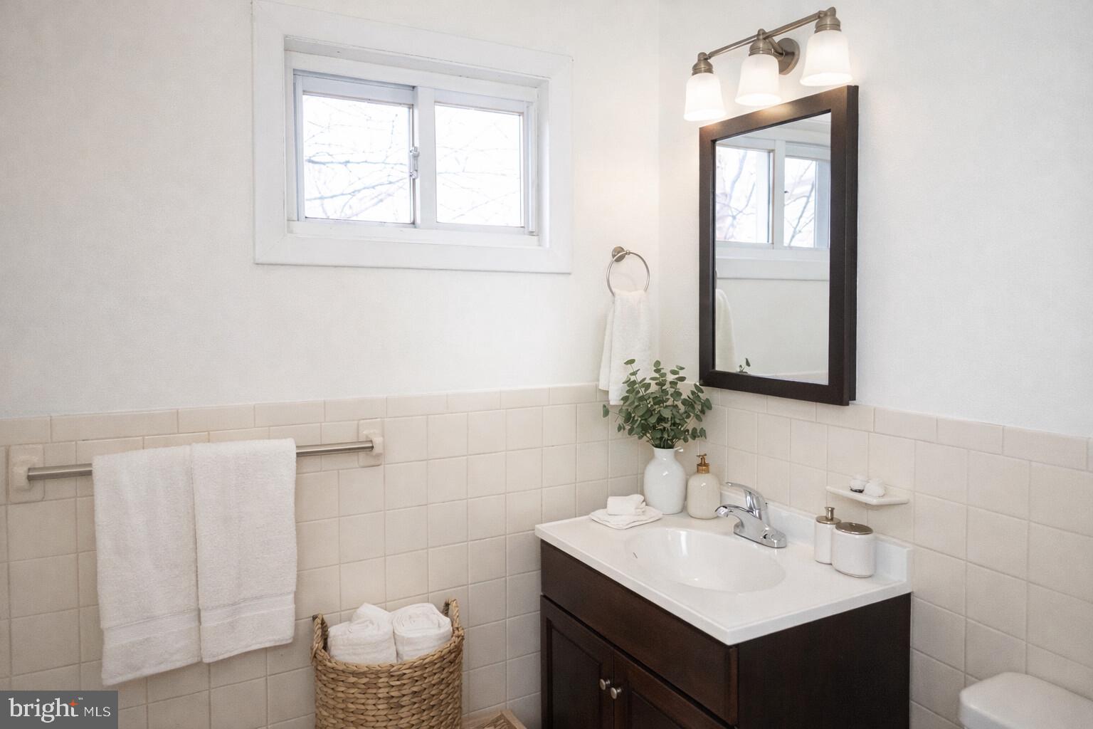 2309 East York Street, Unit 2R Philadelphia, PA 19125 - Photo 5 of 8 a bathroom with a sink vanity and a mirror