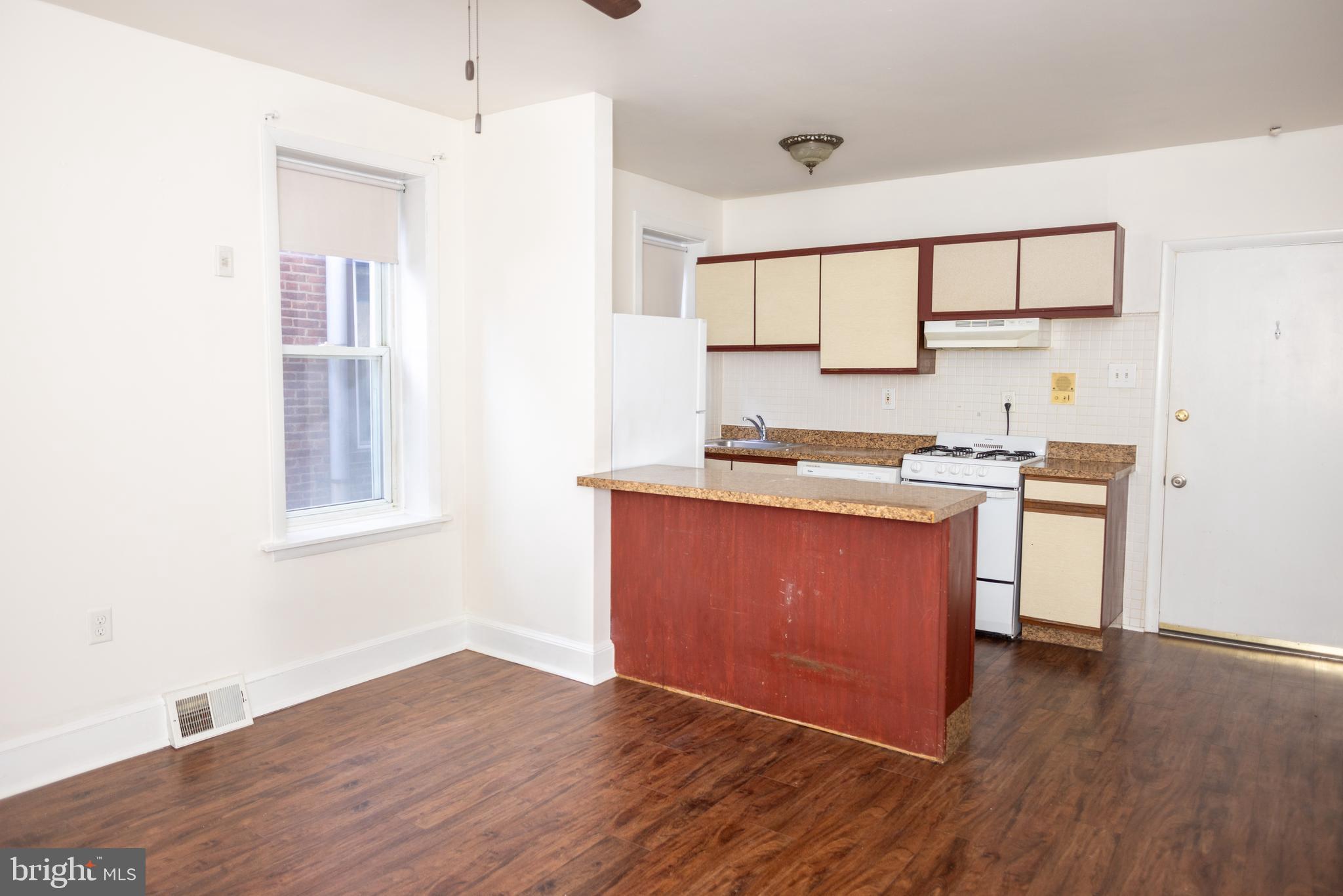 2309 East York Street, Unit 2R Philadelphia, PA 19125 - Photo 6 of 8 a kitchen with wooden floors and a window