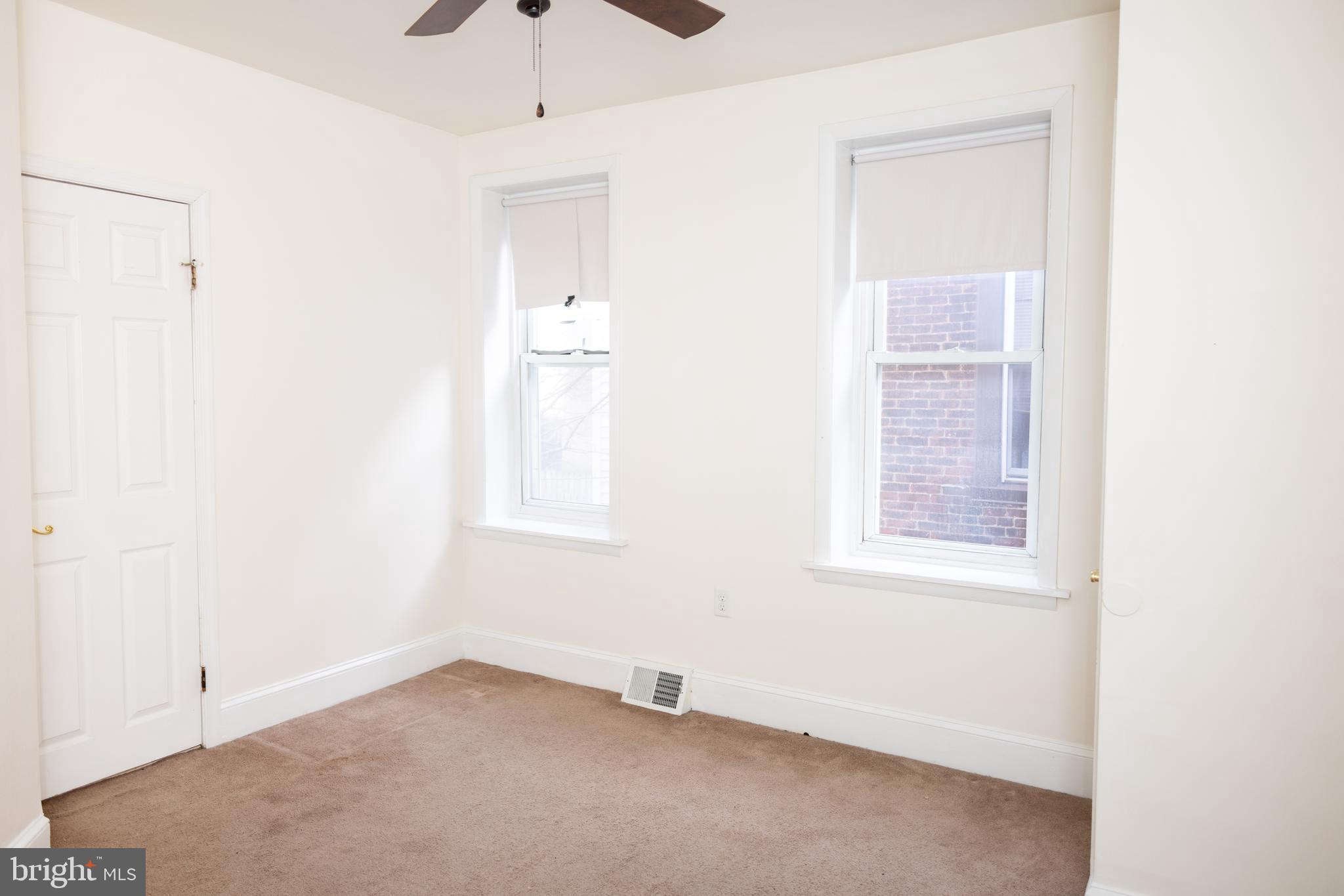 2309 East York Street, Unit 2R Philadelphia, PA 19125 - Photo 7 of 8 an empty room with windows and closet
