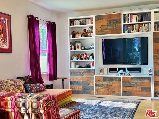 a bedroom with furniture and a book shelf