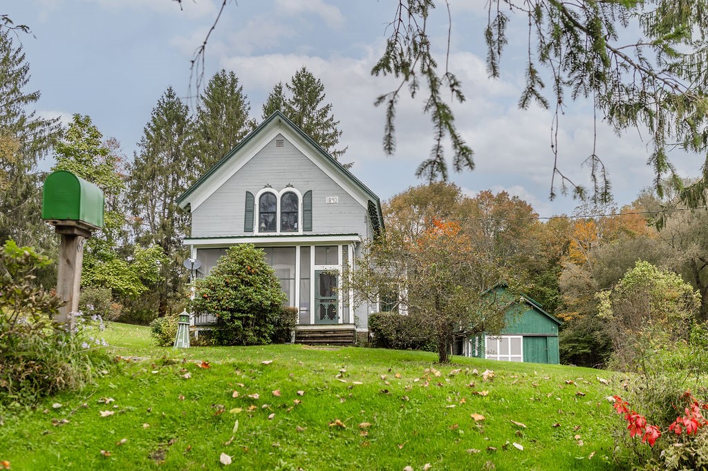 67 Fisk Road Bovina, NY 13753 - Photo 3 of 48 Charming historic architecture highlights this classic gabled home set on a grassy lawn.