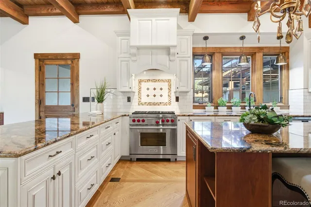 a kitchen with stainless steel appliances granite countertop a stove and a sink