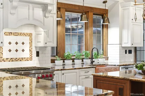 a kitchen with stainless steel appliances a sink and a stove next to a window