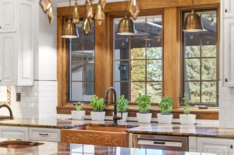 a kitchen with granite countertop a sink and a window