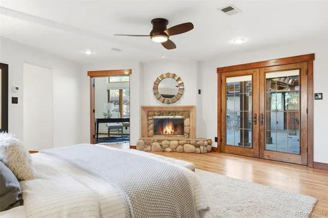 a bedroom with a bed and a large window