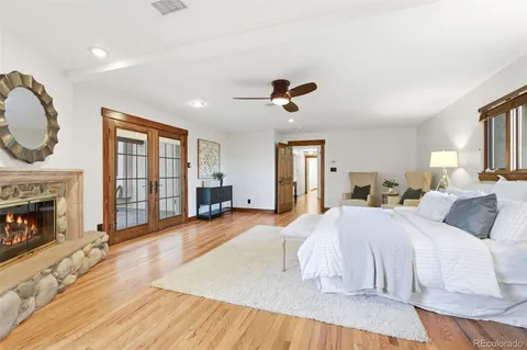 a spacious bedroom with a large bed and a fireplace