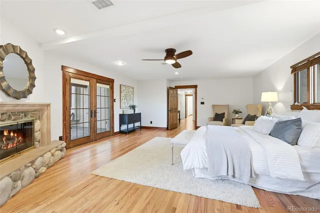 a spacious bedroom with a large bed and a fireplace