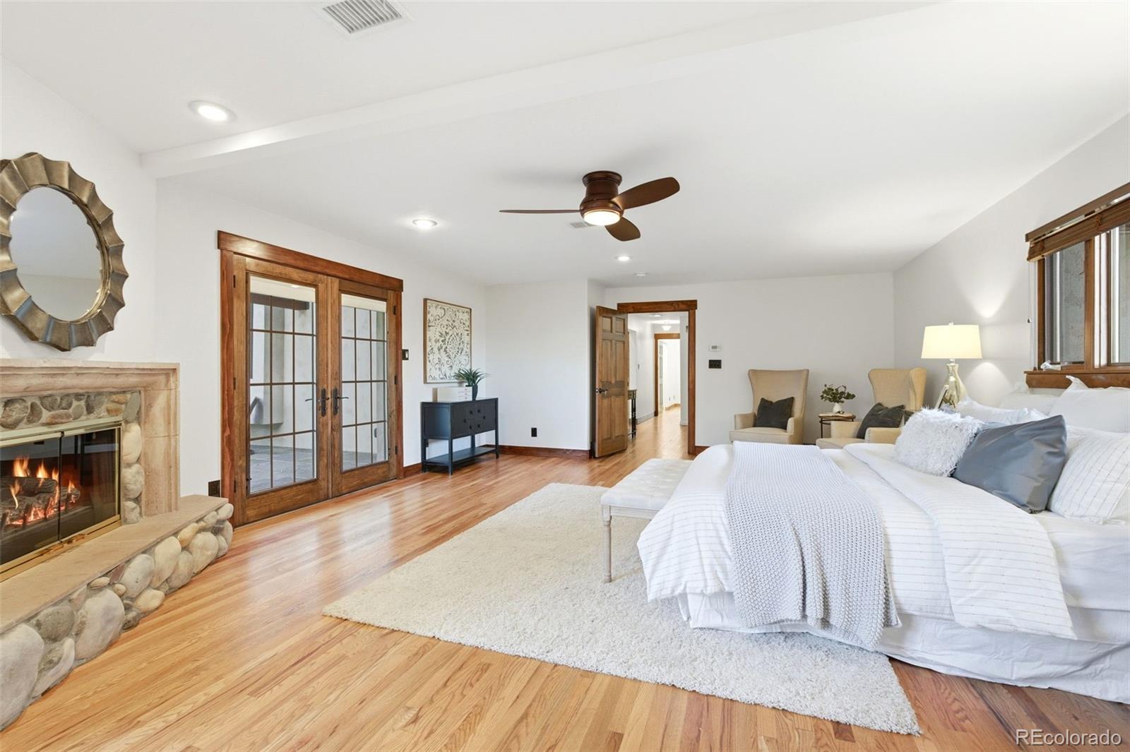 2305 Cherryville Road Greenwood Village, CO 80121 - Photo 21 of 50 a spacious bedroom with a large bed and a fireplace