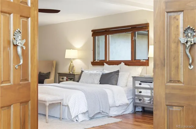 a bedroom with a bed and a mirror