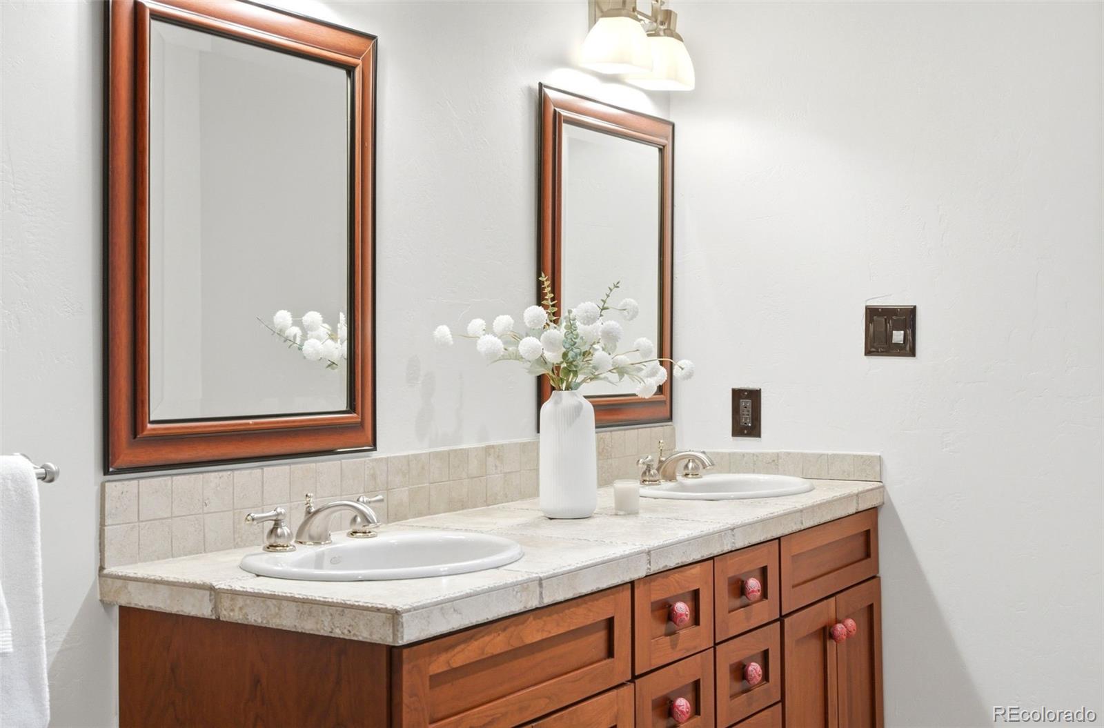 2305 Cherryville Road Greenwood Village, CO 80121 - Photo 25 of 50 a bathroom with a sink and a mirror