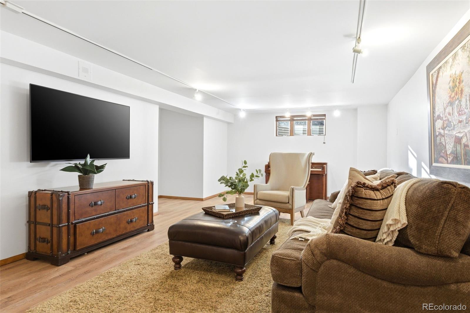 2305 Cherryville Road Greenwood Village, CO 80121 - Photo 32 of 50 a living room with furniture and a flat screen tv
