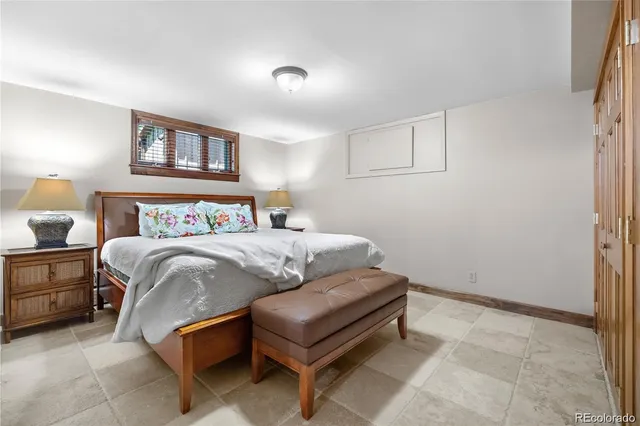 a bedroom with a bed and a night stand