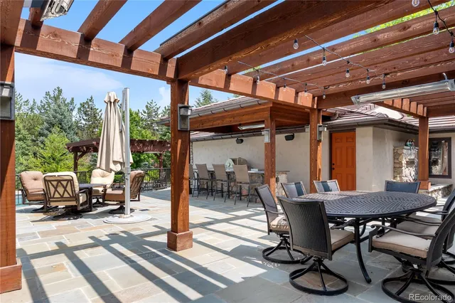 a view of a patio with table and chairs and potted plants