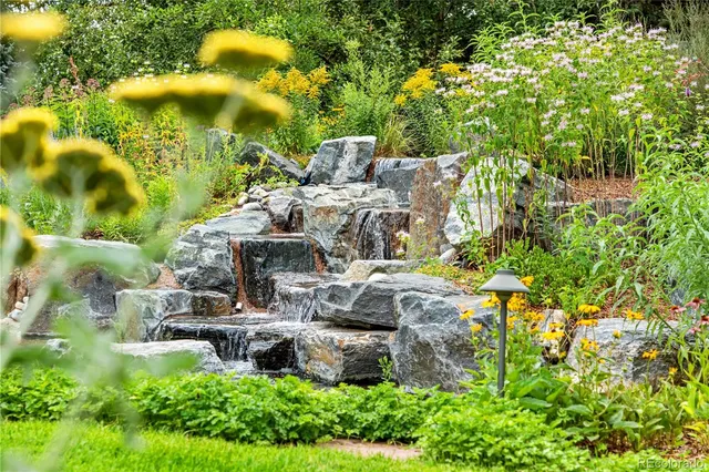 a view of a fountain in middle of the green field