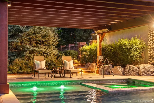 a swimming pool with outdoor seating and yard