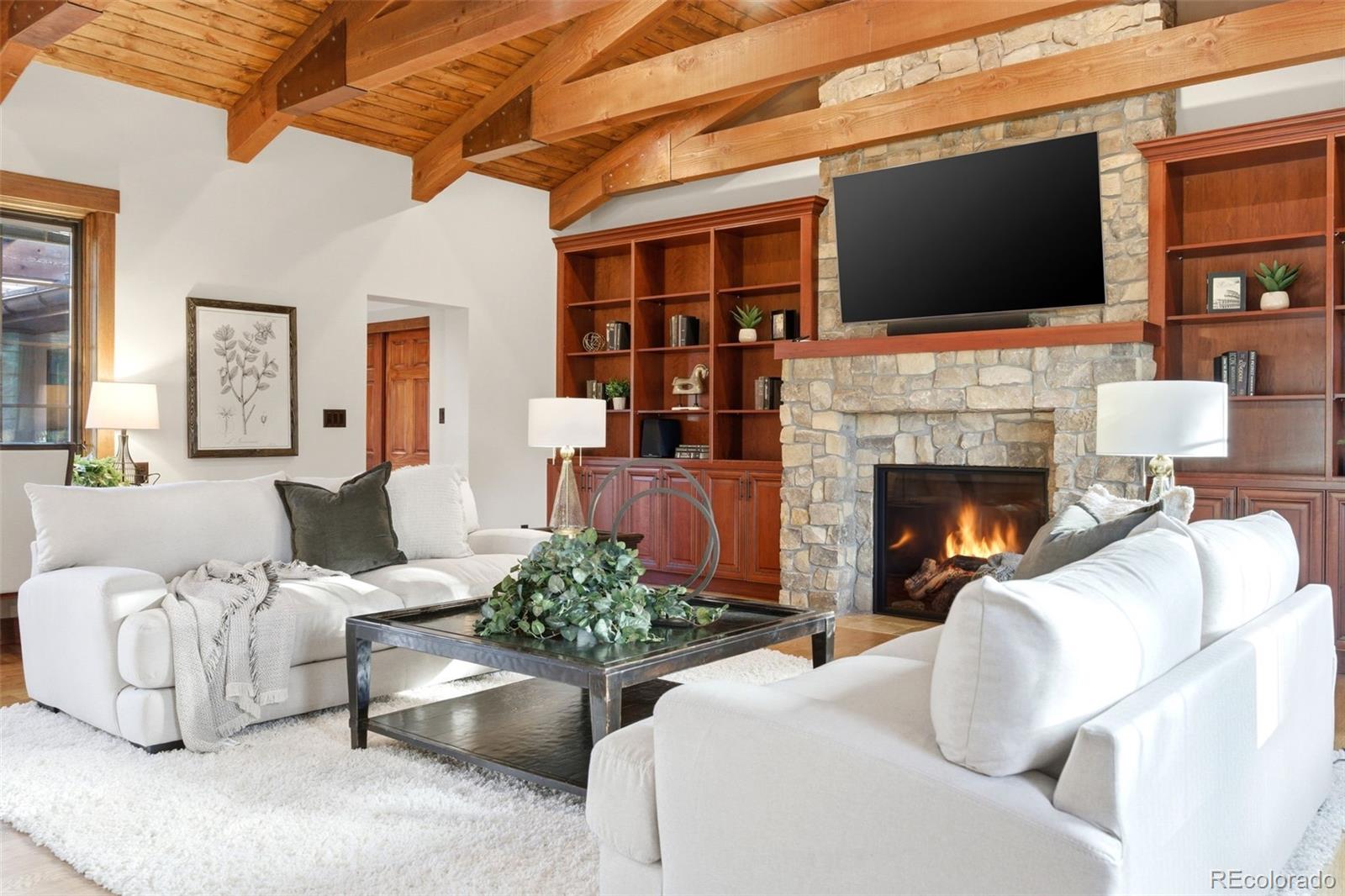 2305 Cherryville Road Greenwood Village, CO 80121 - Photo 5 of 50 a living room with furniture a fireplace and a flat screen tv